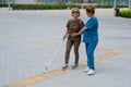 A nurse accompanies an elderly blind woman on a walk. Royalty Free Stock Photo