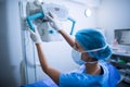 Nurse adjusting x-ray machine over patient Royalty Free Stock Photo