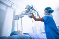 Nurse adjusting x-ray machine over patient Royalty Free Stock Photo