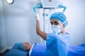 Nurse adjusting x-ray machine over patient Royalty Free Stock Photo