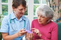 Nurse Advising Senior Woman On Medication At Home Royalty Free Stock Photo