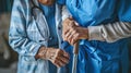 a nurse aids an elderly woman in standing up, their hands firmly gripping her walking stick, both dressed in a blue