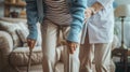 a nurse aids an elderly woman in standing up, their hands firmly gripping her walking stick, both dressed in a blue