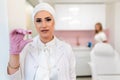 Nurse with ampoule of medicine in her hand