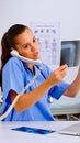 Nurse answering at hospital call checking the result of patient x-ray Royalty Free Stock Photo