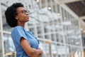 Nurse, arms crossed and thinking with black woman in hospital for medical, idea and expert. Medicine, healthcare and Royalty Free Stock Photo