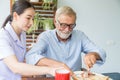 Nurse assist senior man having breakfast together Royalty Free Stock Photo