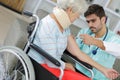Nurse assisting wheelchair with senior woman at home Royalty Free Stock Photo