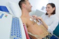 Nurse attaching heart monitor pads to patient