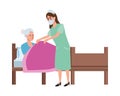 Nurse attending old woman in bed