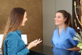 Nurse attending patient in a reception desk