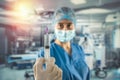 nurse in blue uniform with gloves mask holding a syringe with medication and waiting for patient Royalty Free Stock Photo