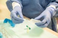 Nurse carefully prepares the material to perform a blood draw on a patient, following safety protocols