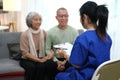 nurse or caregiver meeting and talking with about health with senior couple Royalty Free Stock Photo