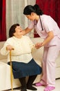 Nurse caring elderly woman at home