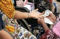 Nurse checking Blood sugar level of woman