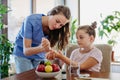 Nurse checking girl's blood glucose level using a fingerstick glucose meter.