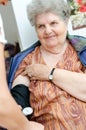 Nurse checking senior woman blood pressure