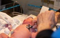 Nurse checks preemie with stethoscope in NICU Royalty Free Stock Photo