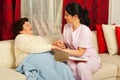 Nurse comforting sick elderly woman