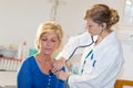 nurse counting heart rate female patient