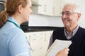 Nurse Discussing Medical Record With Senior Male Patient Royalty Free Stock Photo