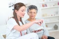 Nurse discussing medication with elderly woman Royalty Free Stock Photo