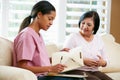 Nurse Discussing Records With Senior Female Patient Royalty Free Stock Photo