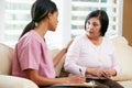 Nurse Discussing Records With Senior Female Patient Royalty Free Stock Photo