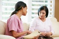 Nurse Discussing Records With Senior Female Patient During Home Royalty Free Stock Photo