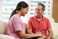 Nurse Discussing Records With Senior Male Patient Royalty Free Stock Photo