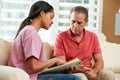 Nurse Discussing Records With Senior Male Patient Royalty Free Stock Photo