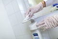 A nurse disinfects an item in a hospital room