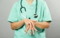 Nurse or Doctor in green outfit and stethoscope is demonstrating washing and cleaning for protection coronavirus or covid-19