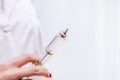 A nurse or doctor holds a reusable glass syringe with the vaccine for injection Royalty Free Stock Photo