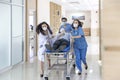 Nurse and doctor in a hurry taking patient to operation theatre. Doctors running for the surgery. Team of doctors and surgeon Royalty Free Stock Photo