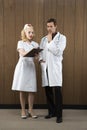 Nurse and doctor looking at clipboard. Royalty Free Stock Photo