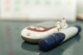 Nurse and Doctor miniature figure with handbag walking on lancet with glucose meter and calender using as diabetes, glycemia,