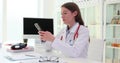 Nurse or doctor with mobile phone reads messages or browses information on Internet.