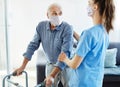 nurse doctor senior care caregiver help walker assistence retirement home nursing man virus mask corona Royalty Free Stock Photo