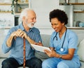 nurse doctor senior care tablet computer technology showing caregiver help assistence retirement home nursing elderly Royalty Free Stock Photo