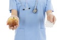 Nurse or doctor showing a pack of tablets and an apple Royalty Free Stock Photo