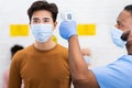 Nurse Doing Temperature Screening For Asian Man Patient In Hospital