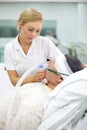 Nurse with dummy patient learns how to fit oxygen mask.