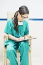 Nurse examining report of patient.