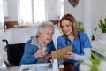 Nurse explaining how to dose medicines to senior woman. Royalty Free Stock Photo