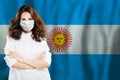 Nurse with face mask against national flag Argentina. Flu epidemic and virus protection concept Royalty Free Stock Photo