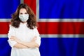 Nurse with face mask against national flag Iceland. Flu epidemic and virus protection concept