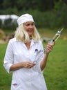 Nurse with a gigantic syringe Royalty Free Stock Photo