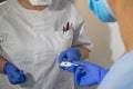 Nurse gives thermometer to another nurse